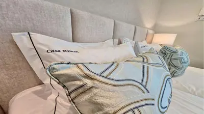 a bed with a comforter and pillows on it at Villa Rimah, Sunny Algarve, Entire Home 