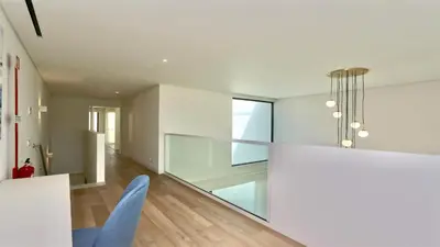 a living room with white walls and a blue chair at Villa Rimah, Sunny Algarve, Entire Home 