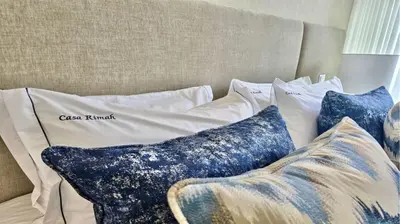 a pile of pillows sitting on a bed at Villa Rimah, Sunny Algarve, Entire Home 