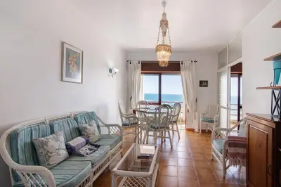 a living room with a couch and a table at Beachfront Apartment T2 in Quarteira