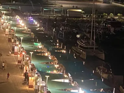 a group of boats parked in a marina at night at Marina Albufeira Best Apartment in Albufeira