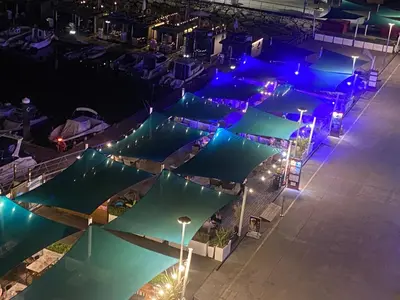 an overhead view of a pool with umbrellas at night at Marina Albufeira Best Apartment in Albufeira