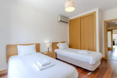 a kitchen with wooden cabinets and a sink at #327 Corcovada 43 Vista Piscina by Home Holidays in Albufeira