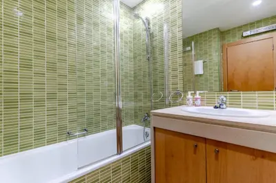 a bathroom with a sink and a bed in a room at #327 Corcovada 43 Vista Piscina by Home Holidays in Albufeira
