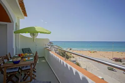 a balcony with a table and a view of the beach at #326 Vista Mar by Home Holidays in Albufeira