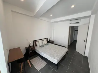 a bedroom with a bed and a desk and a table at Train Station Guesthouse in Faro