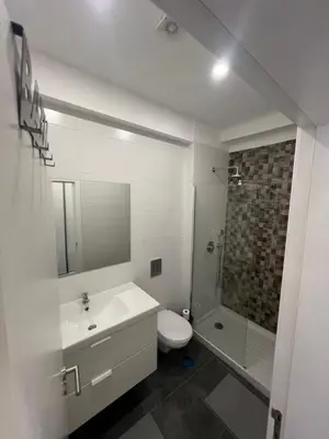 a bathroom with a sink and a toilet and a shower at Train Station Guesthouse in Faro