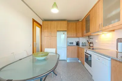 a kitchen with a table and a counter top at Entre o Vale e o Mar - Vale Parra in Guia