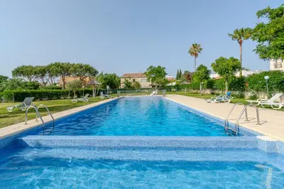a swimming pool in a resort with chairs and trees at Entre o Vale e o Mar - Vale Parra in Guia