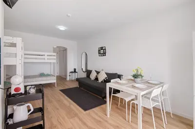 a living room with a couch and a table and a bed at The Oura Stay in Albufeira