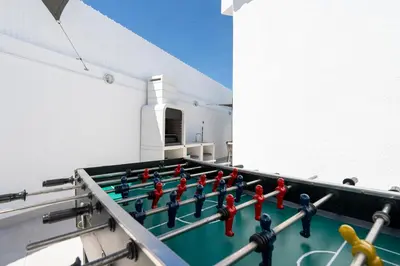 a group of lego men playing a game on a table at Alma Invicta Albufeira in Albufeira