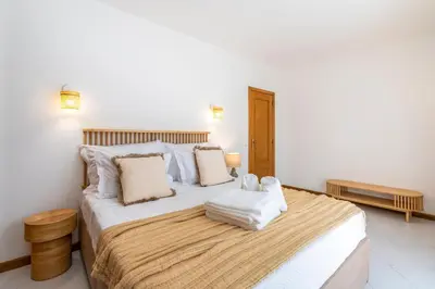 a bedroom with a large bed with towels on it at Alma Invicta Albufeira in Albufeira