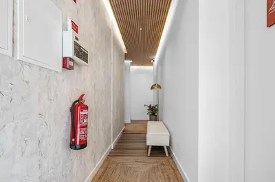 a bedroom with a large bed with red and white pillows at Urban Bliss Boutique Guesthouse in Faro