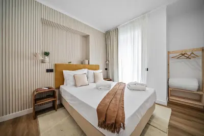 a bedroom with a bed with a blanket on it at Urban Bliss Boutique Guesthouse in Faro