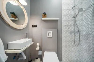 a bathroom with a shower and a sink and a mirror at Urban Bliss Boutique Guesthouse in Faro