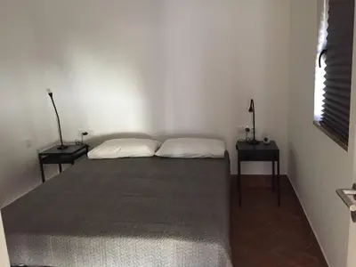 a bedroom with a bed with two nightstands and two lamps at Pátio da Várzea in Albufeira