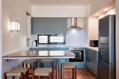 a kitchen with a counter and stools in it at Apartment Green Oasis in Albufeira Jardim mit Pool in Albufeira