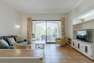 a living room with a couch and a table at Apartment Green Oasis in Albufeira Jardim mit Pool in Albufeira