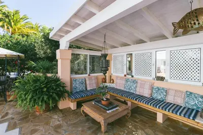 a porch with a bench and a table at Traumhaft schöne Villa mit Pool und Meerblick in Albufeira