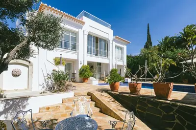 a villa with a swimming pool and a house at Traumhaft schöne Villa mit Pool und Meerblick in Albufeira