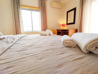 a bedroom with a large bed with towels on it at Sol Mar Penthouse by Da Costa in Albufeira