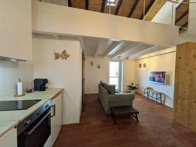 a bedroom with a large bed in an attic at Laranjeira 2 by AlmaAlgarvia in Santa Bárbara de Nexe