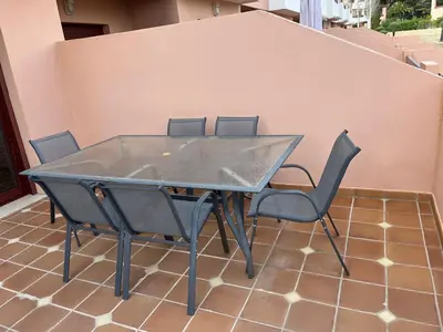 a kitchen with wooden cabinets and a sink at Villa Filó , Vila Sol with pool in Quarteira