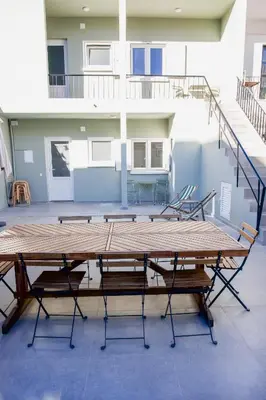 a large wooden table in a room with chairs at Casas Sao Luis in Faro