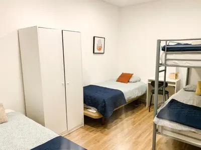 a bedroom with two beds and a bunk bed at Casas Sao Luis in Faro