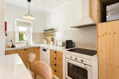 a kitchen with a sink and a stove top oven at Casa Bela Mar in Albufeira