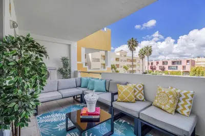 a living room with two couches and a table at Falesia Marina in Quarteira