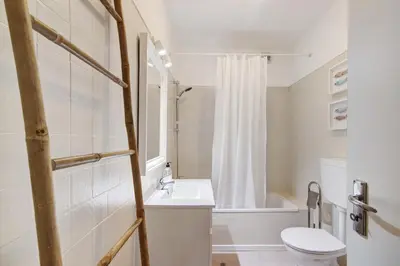 a white bathroom with a sink and a toilet at Apartamento Mar Azul - Quarteira in Quarteira