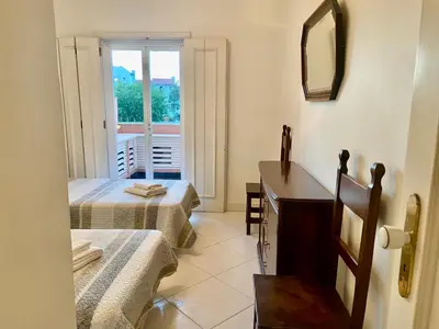 a room with two beds and a sink and a mirror at Vila Lusa Marina in Vilamoura