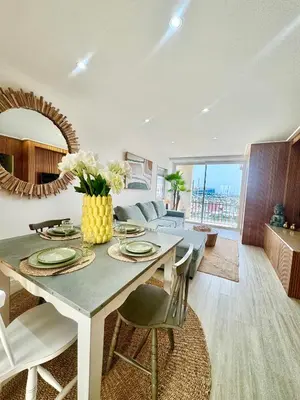 a living room with a table and a couch at FM Marina Vilamoura in Quarteira