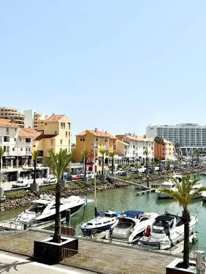 a group of boats docked in a marina with buildings at FM Marina Vilamoura in Quarteira
