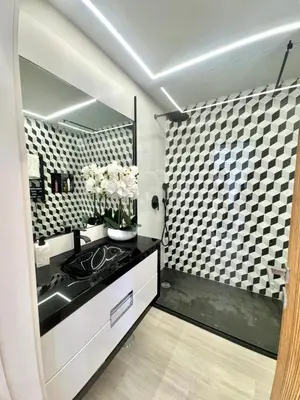 a bathroom with a black and white checkered wall at FM Marina Vilamoura in Quarteira