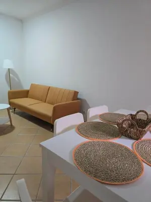 a room with a table and chairs and a couch at Casa Alfazema in Faro