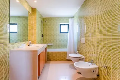 a bathroom with a sink and a toilet at Penthouse with Pool View in Albufeira by Lovelystay in Albufeira