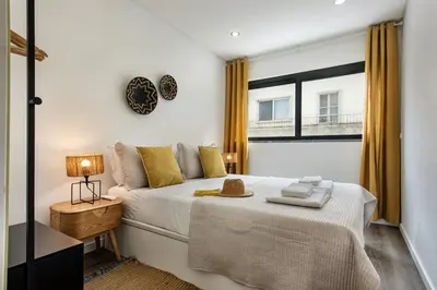 a bedroom with a bed and a clock on the wall at Stay Apartment in Faro
