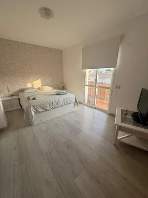 a bedroom with a bed and a television in it at Modern apartment in Al-sakia Village in Quarteira