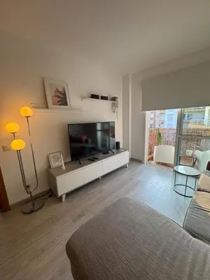 a living room with a large flat screen tv at Modern apartment in Al-sakia Village in Quarteira