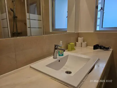 a white sink in a bathroom with a mirror at Blife Cerya private rooms at Faro beach in Faro