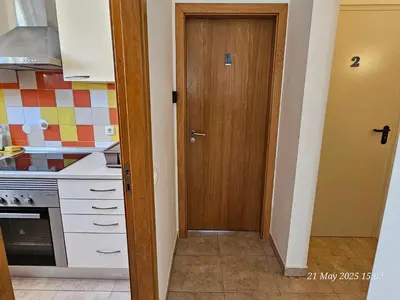 a kitchen with a door leading into a kitchen at Blife Cerya private rooms at Faro beach in Faro