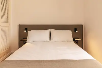 a bedroom with a large bed with two pillows at Aldeamento Aldeia do Golf V3 in Vilamoura