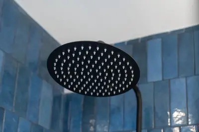 a black lamp sitting in front of a blue wall at Modern 1BDR with Sea View in Albufeira by LovelyStay in Albufeira