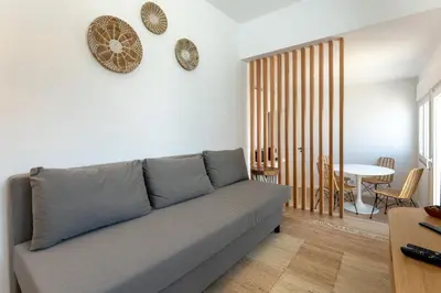 a living room with a couch and a table at Modern 1BDR with Sea View in Albufeira by LovelyStay in Albufeira