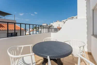 a table and two chairs on a balcony at Modern 1BDR with Sea View in Albufeira by LovelyStay in Albufeira