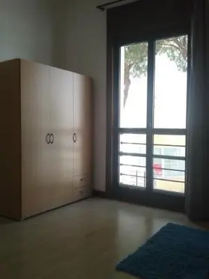 an empty room with a large window and a dresser at 2 bedroom Apartment Falésia Beach in Albufeira