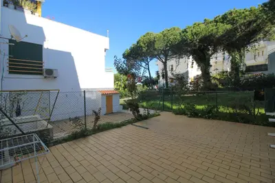 a fence in front of a building with a patio at 2 bedroom Apartment Falésia Beach in Albufeira