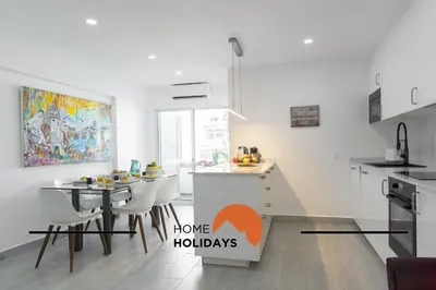 a kitchen with a table and a dining room at #317 Edificio Linda Vista by Home Holidays in Albufeira